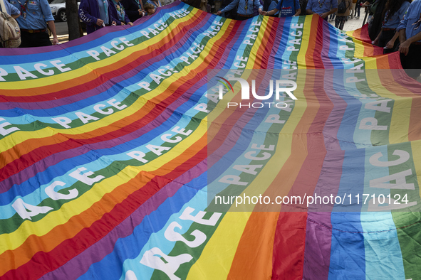 Thousands of people march through Bari, Italy, on October 26, 2024, with banners and flags during a peace rally titled ''Stop the wars, the...