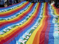 Thousands of people march through Bari, Italy, on October 26, 2024, with banners and flags during a peace rally titled ''Stop the wars, the...