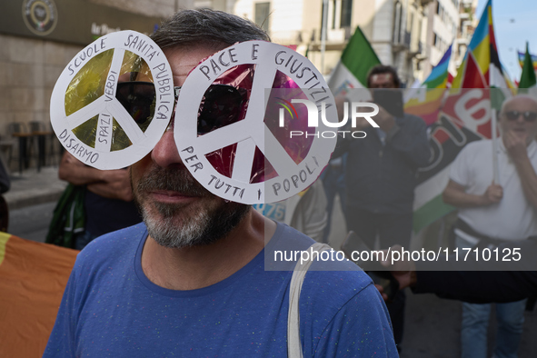 Thousands of people march through Bari, Italy, on October 26, 2024, with banners and flags during a peace rally titled ''Stop the wars, the...