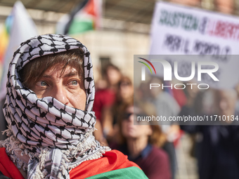 Thousands of people march through Bari, Italy, on October 26, 2024, with banners and flags during a peace rally titled ''Stop the wars, the...