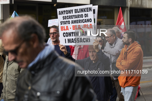 Thousands of people march through Bari, Italy, on October 26, 2024, with banners and flags during a peace rally titled ''Stop the wars, the...