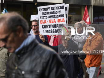 Thousands of people march through Bari, Italy, on October 26, 2024, with banners and flags during a peace rally titled ''Stop the wars, the...