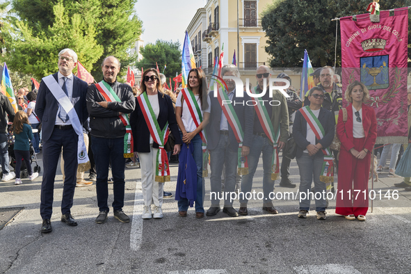 Thousands of people march through Bari, Italy, on October 26, 2024, with banners and flags during a peace rally titled ''Stop the wars, the...