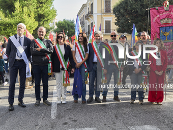 Thousands of people march through Bari, Italy, on October 26, 2024, with banners and flags during a peace rally titled ''Stop the wars, the...