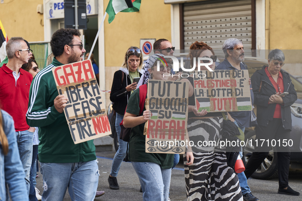 Thousands of people march through Bari, Italy, on October 26, 2024, with banners and flags during a peace rally titled ''Stop the wars, the...