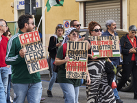 Thousands of people march through Bari, Italy, on October 26, 2024, with banners and flags during a peace rally titled ''Stop the wars, the...