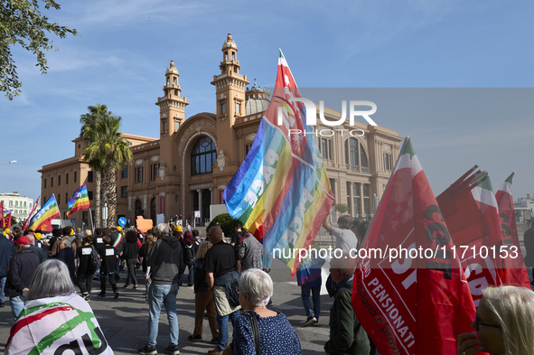 Thousands of people march through Bari, Italy, on October 26, 2024, with banners and flags during a peace rally titled ''Stop the wars, the...