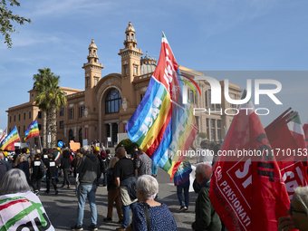 Thousands of people march through Bari, Italy, on October 26, 2024, with banners and flags during a peace rally titled ''Stop the wars, the...