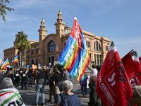 Thousands of people march through Bari, Italy, on October 26, 2024, with banners and flags during a peace rally titled ''Stop the wars, the...