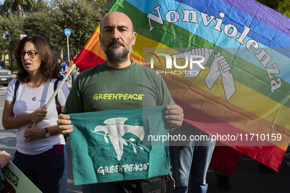 Thousands of people march through Bari, Italy, on October 26, 2024, with banners and flags during a peace rally titled ''Stop the wars, the...