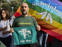 Thousands of people march through Bari, Italy, on October 26, 2024, with banners and flags during a peace rally titled ''Stop the wars, the...