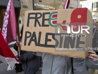 Thousands of people march through Bari, Italy, on October 26, 2024, with banners and flags during a peace rally titled ''Stop the wars, the...