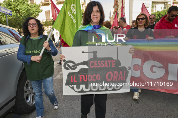 Thousands of people march through Bari, Italy, on October 26, 2024, with banners and flags during a peace rally titled ''Stop the wars, the...