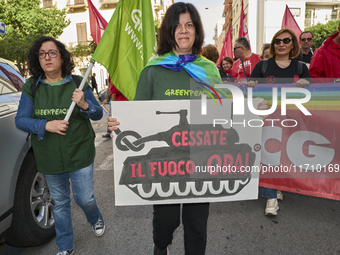 Thousands of people march through Bari, Italy, on October 26, 2024, with banners and flags during a peace rally titled ''Stop the wars, the...