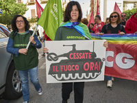 Thousands of people march through Bari, Italy, on October 26, 2024, with banners and flags during a peace rally titled ''Stop the wars, the...