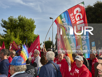 Thousands of people march through Bari, Italy, on October 26, 2024, with banners and flags during a peace rally titled ''Stop the wars, the...