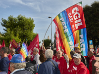 Thousands of people march through Bari, Italy, on October 26, 2024, with banners and flags during a peace rally titled ''Stop the wars, the...