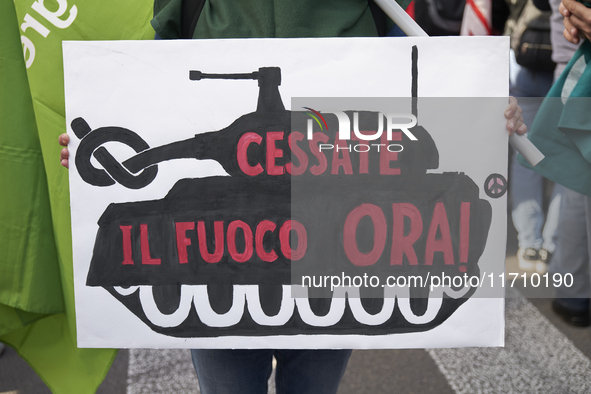 Thousands of people march through Bari, Italy, on October 26, 2024, with banners and flags during a peace rally titled ''Stop the wars, the...