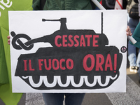 Thousands of people march through Bari, Italy, on October 26, 2024, with banners and flags during a peace rally titled ''Stop the wars, the...