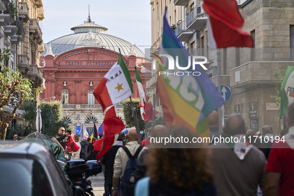 Thousands of people march through Bari, Italy, on October 26, 2024, with banners and flags during a peace rally titled ''Stop the wars, the...