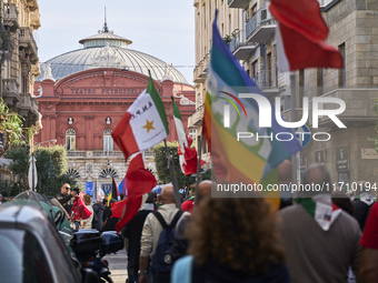 Thousands of people march through Bari, Italy, on October 26, 2024, with banners and flags during a peace rally titled ''Stop the wars, the...