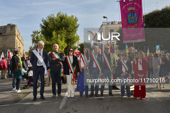 Thousands of people march through Bari, Italy, on October 26, 2024, with banners and flags during a peace rally titled ''Stop the wars, the...