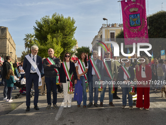 Thousands of people march through Bari, Italy, on October 26, 2024, with banners and flags during a peace rally titled ''Stop the wars, the...