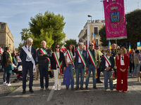 Thousands of people march through Bari, Italy, on October 26, 2024, with banners and flags during a peace rally titled ''Stop the wars, the...