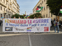 Thousands of people march through Bari, Italy, on October 26, 2024, with banners and flags during a peace rally titled ''Stop the wars, the...