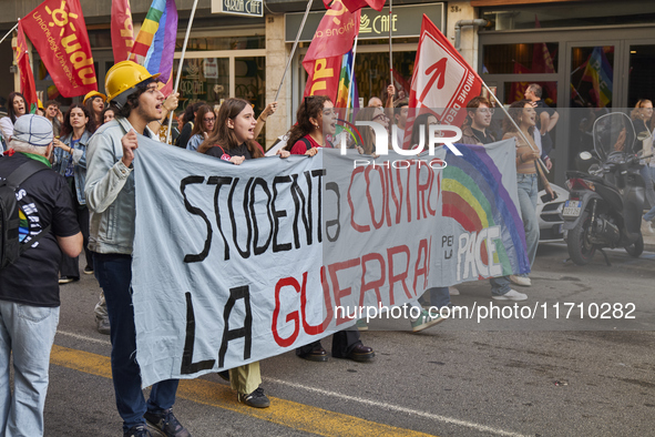 Thousands of people march through Bari, Italy, on October 26, 2024, with banners and flags during a peace rally titled ''Stop the wars, the...