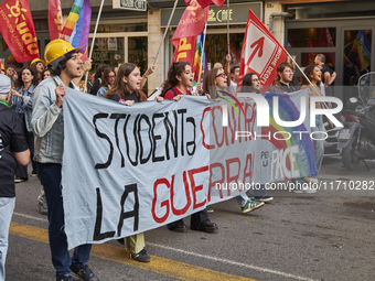 Thousands of people march through Bari, Italy, on October 26, 2024, with banners and flags during a peace rally titled ''Stop the wars, the...