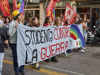 Thousands of people march through Bari, Italy, on October 26, 2024, with banners and flags during a peace rally titled ''Stop the wars, the...