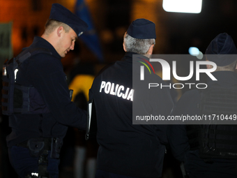 Police attend a protest against Jaroslaw Kaczynski's monthly visit to Wawel Hill in Krakow, Poland, on October 18, 2024. Every 18th day of t...