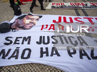 Banners are seen during a demonstration in Lisbon, Portugal, on October 26, 2024. Participants protest the death of Cape Verdean immigrant O...