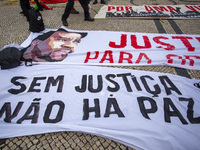 Banners are seen during a demonstration in Lisbon, Portugal, on October 26, 2024. Participants protest the death of Cape Verdean immigrant O...