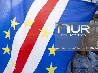 Demonstrators march holding flags in Lisbon, Portugal, on October 26, 2024. They protest the death of Cape Verdean immigrant Odair Moniz, a...