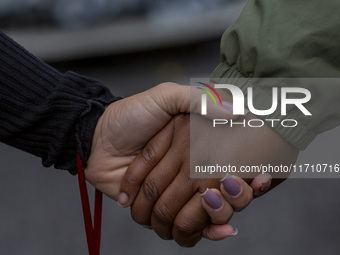 In Lisbon, Portugal, on October 26, 2024, demonstrators hold hands during a protest. They protest the death of Cape Verdean immigrant Odair...