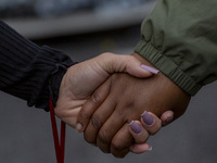 In Lisbon, Portugal, on October 26, 2024, demonstrators hold hands during a protest. They protest the death of Cape Verdean immigrant Odair...