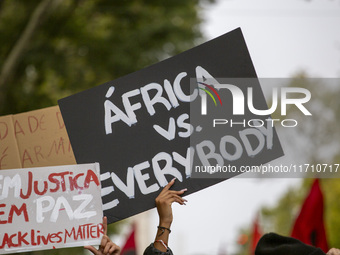 Demonstrators march holding banners in Lisbon, Portugal, on October 26, 2024. They protest the death of Cape Verdean immigrant Odair Moniz,...