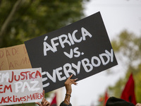 Demonstrators march holding banners in Lisbon, Portugal, on October 26, 2024. They protest the death of Cape Verdean immigrant Odair Moniz,...