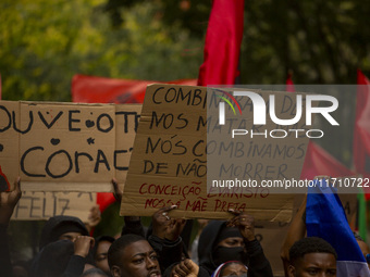 Demonstrators march holding banners in Lisbon, Portugal, on October 26, 2024. They protest the death of Cape Verdean immigrant Odair Moniz,...