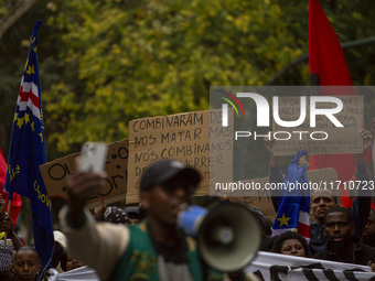 Demonstrators march holding banners in Lisbon, Portugal, on October 26, 2024. They protest the death of Cape Verdean immigrant Odair Moniz,...