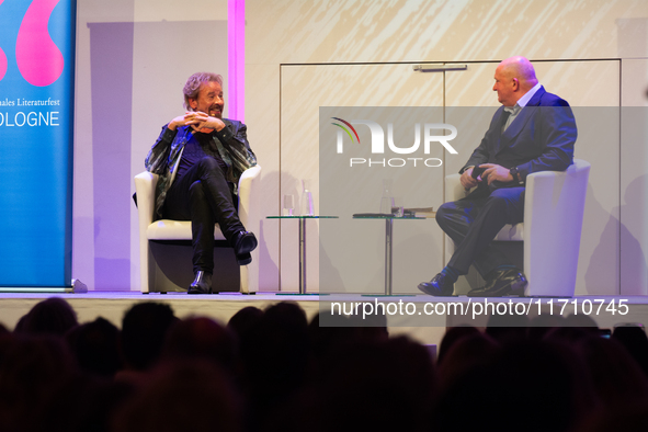 Thomas Johannes Gottschalk, a German television host, and Jorg Thadeusz, a German journalist, are seen on the stage at Flora Hall in Cologne...