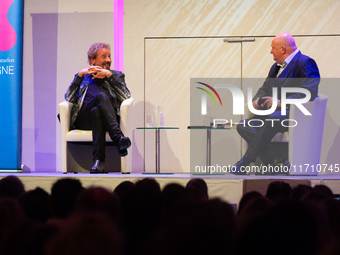 Thomas Johannes Gottschalk, a German television host, and Jorg Thadeusz, a German journalist, are seen on the stage at Flora Hall in Cologne...