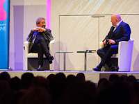 Thomas Johannes Gottschalk, a German television host, and Jorg Thadeusz, a German journalist, are seen on the stage at Flora Hall in Cologne...