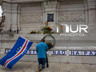 In Lisbon, Portugal, on October 26, 2024, a man prays before an improvised memorial with the picture of Odair Moniz at Praca dos Restaurador...