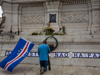 In Lisbon, Portugal, on October 26, 2024, a man prays before an improvised memorial with the picture of Odair Moniz at Praca dos Restaurador...