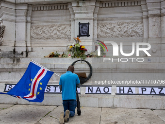 In Lisbon, Portugal, on October 26, 2024, a man prays before an improvised memorial with the picture of Odair Moniz at Praca dos Restaurador...