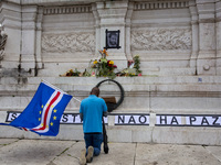 In Lisbon, Portugal, on October 26, 2024, a man prays before an improvised memorial with the picture of Odair Moniz at Praca dos Restaurador...