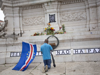 In Lisbon, Portugal, on October 26, 2024, a man prays before an improvised memorial with the picture of Odair Moniz at Praca dos Restaurador...